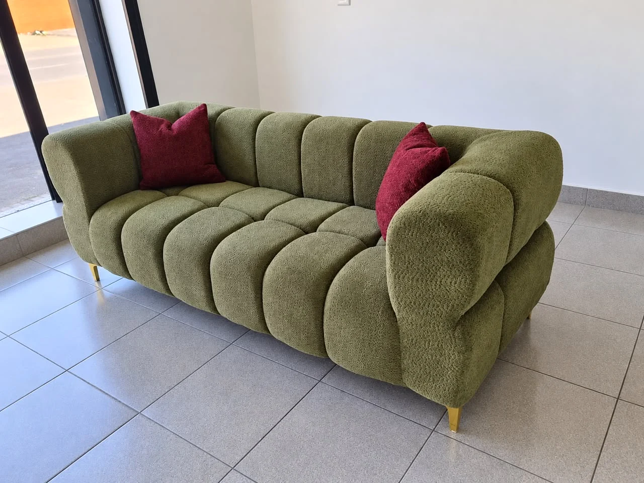 Olive bubble sofa with burgundy cushions and gold feet